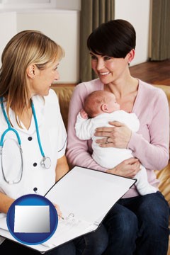 a midwife with a young mother and her baby - with Wyoming icon