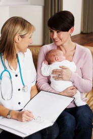 a midwife with a young mother and her baby